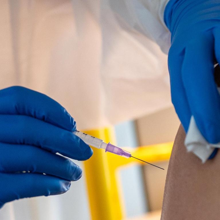 Eine Ärztin impft eine Frau gegen Corona-Virus