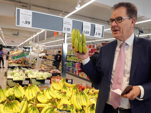 Gerd Müller (CSU), Bundesentwicklungsminister, informiert sich in einem Berliner Lidl-Supermarkt zu fairem Einkauf und wird dabei vom Vorsitzenden der Geschäftsleitung von Lidl Deutschland bei einem gemeinsamen Supermarkt-Rundgang begleitet.