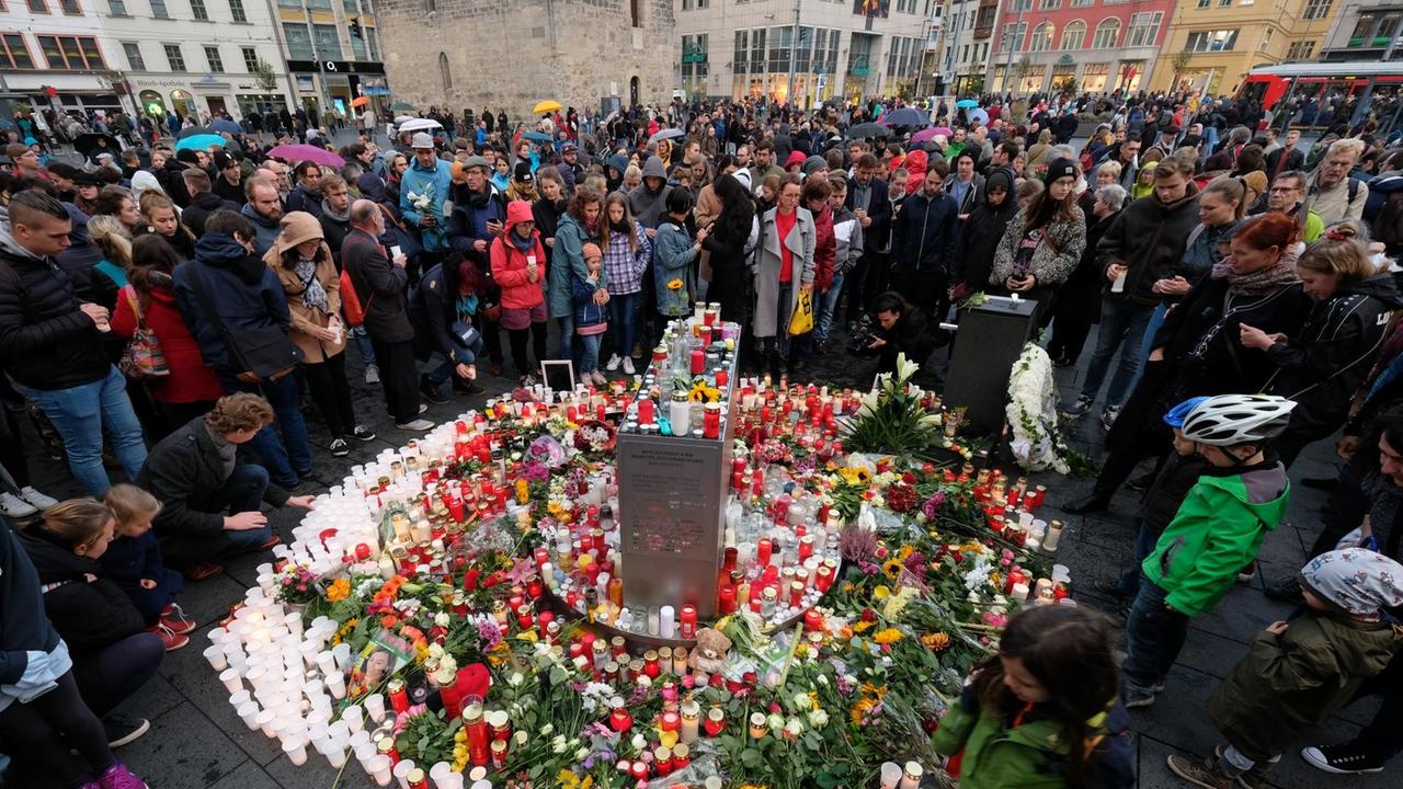 Halles Einwohner und Gäste der Stadt trauern seit dem Anschlag auf die Synagoge öffentlich auf dem Marktplatz, zünden tausende Kerzen an und legen Blumen nieder