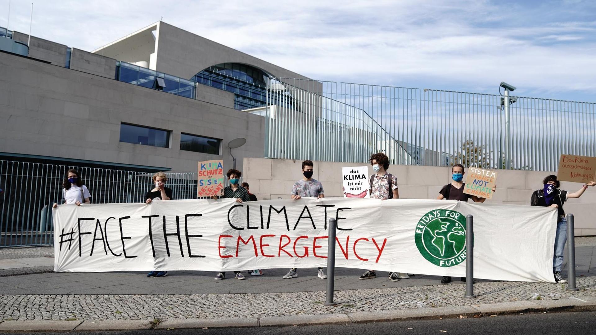 Klimaaktivisten der Fridays for Future Bewegung stehen am Morgen vor dem Bundeskanzleramt mit dem Banner "Face the Climate Emergency". Die Bundeskanzlerin empfängt die führenden Aktivistinnen der Klimaschutz-Bewegung Thunberg und Neubauer im Kanzleramt zum Gespräch. Klimaaktivisten der Fridays for Future Bewegung stehen am Morgen vor dem Bundeskanzleramt mit dem Banner "Face the Climate Emergency". Die Bundeskanzlerin empfängt die führenden Aktivistinnen der Klimaschutz-Bewegung Thunberg und Neubauer im Kanzleramt zum Gespräch.