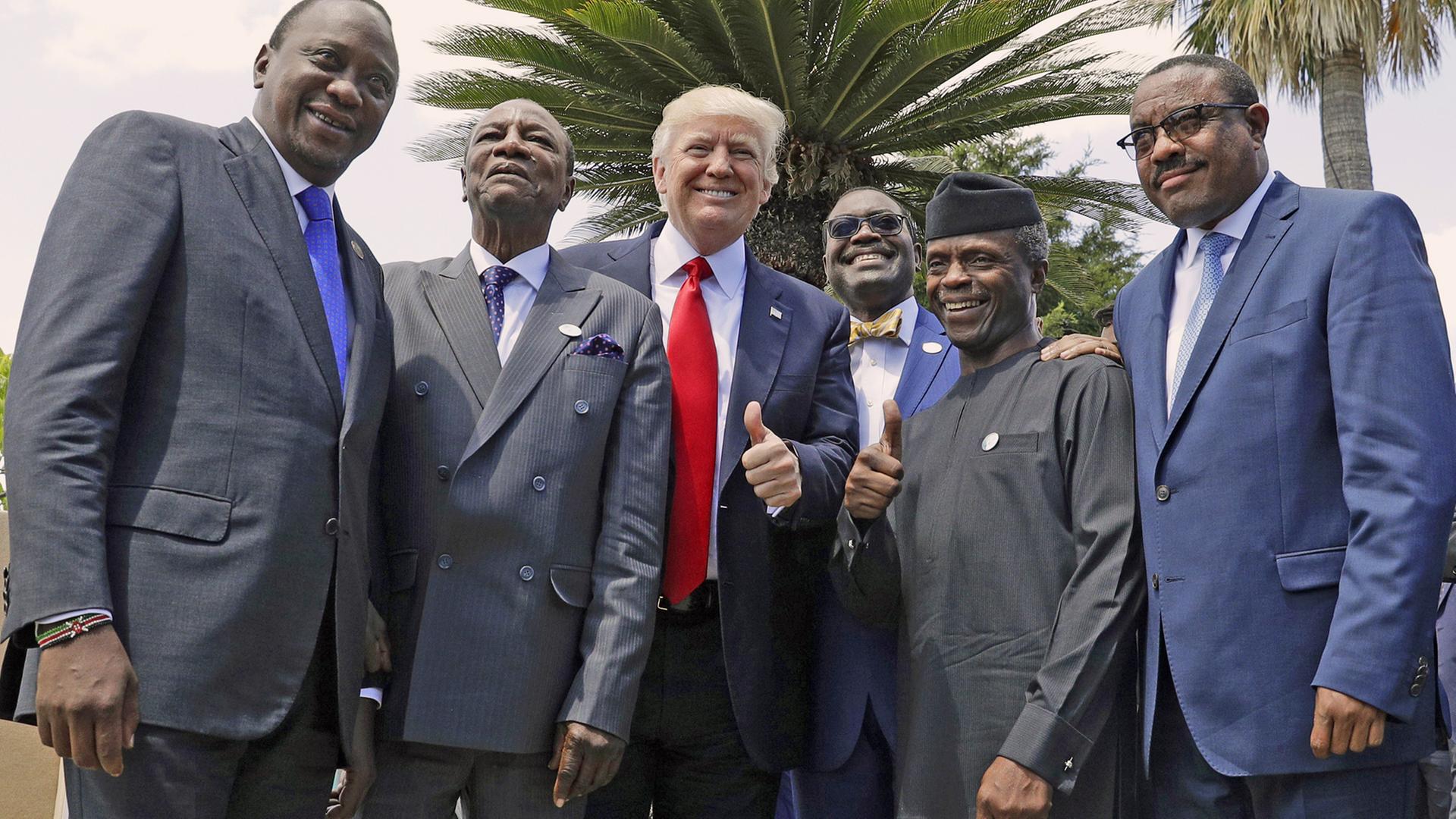 Am 27.5.2017 beim G7-Gipfel in Taormina posieren (v.l.n.r.) Kenias Präsident Uhuru Kenyatta, der Chef der Afrikanischen Union Alpha Conde, US-Präsident Donald Trump, der Präsident der Afrikanischen Entwicklungsbank Bank Akinwumi Adesina, Nigerias Vizepräsident Yemi Osinbajo und Äthiopiens Premierminister Haile Mariam Desalegn unter Palmen für die Fotografen. Am 27.5.2017 beim G7-Gipfel in Taormina posieren (v.l.n.r.) Kenias Präsident Uhuru Kenyatta, der Chef der Afrikanischen Union Alpha Conde, US-Präsident Donald Trump, der Präsident der Afrikanischen Entwicklungsbank Bank Akinwumi Adesina, Nigerias Vizepräsident Yemi Osinbajo und Äthiopiens Premierminister Haile Mariam Desalegn unter Palmen für die Fotografen.
