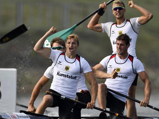 Vier Kanusportler in ihrem Kanu freuen sich über die gewonnene Weltmeisterschaft.