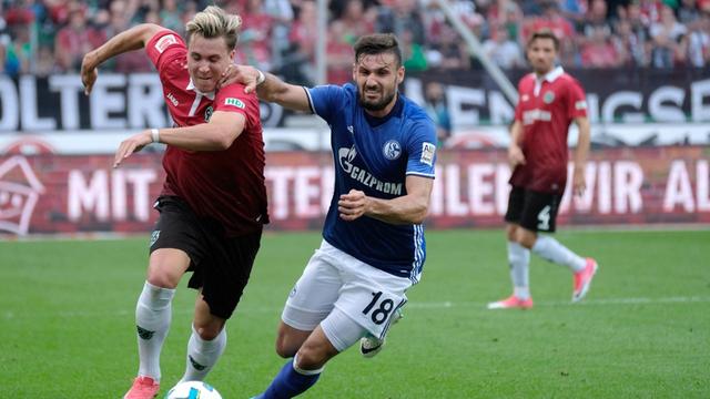 Hannovers Felix Klaus und Schalkes Daniel Caligiuri kämpfen am 27. August 2017 beim Fußball-Bundesliga-Spiel um den Ball.
