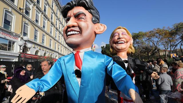 Künstler mit Puppen der französischen Präsidentschaftskandidaten Marine Le Pen und Jean-Luc Mélenchon