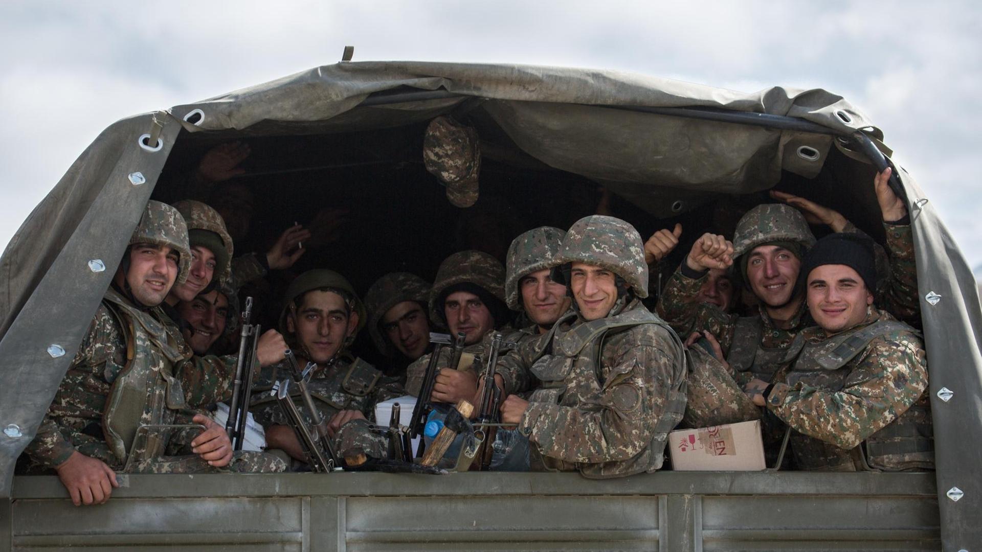 Blick auf einen LKW in dem mehrere Soldaten sitzen Blick auf einen LKW in dem mehrere Soldaten sitzen