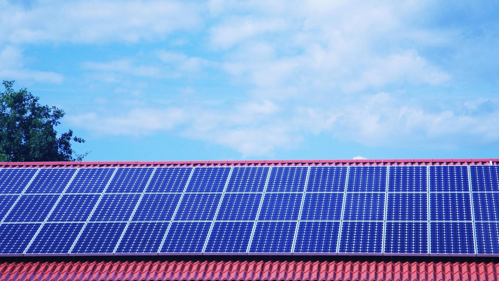 Sonnenkollektoren, auch Solarkollektoren genannt, auf einem Dach eines Privathauses Sonnenkollektoren, auch Solarkollektoren genannt, auf einem Dach eines Privathauses