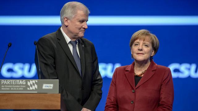 Bundeskanzlerin Angela Merkel (CDU) unterhält sich am 20.11.2015 auf dem CSU-Parteitag in München (Bayern) mit dem bayerischen Ministerpräsidenten Horst Seehofer (CSU).