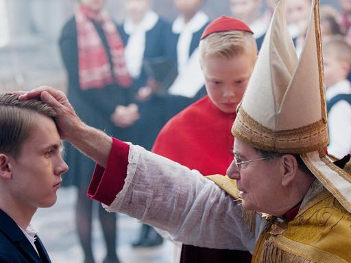 Kardinal Barbarin (François Marthouret) bei der Firmung von Alexandres Sohn Gauthier Guérin (Max Libert)