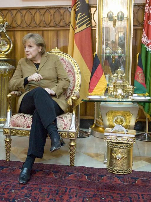 Bundeskanzlerin Angela Merkel am 06.04.2009 in Masar-i-Sharif in Afghanistan während eines Treffens mit dem Provinzgouverneur von Balkh, Mohammad Atta und Bundesverteidigungsminister Franz Josef Jung.
