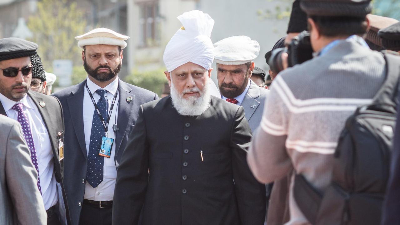 Kalif Hadhrat Mirza Masroor (M), das geistliche Oberhaupt der muslimischen Gemeinschaft Ahmadiyya Muslim Jamaat, kommt am 14.04.2017 in Raunheim (Hessen) zum Freitagsgebet auf dem Grundstück einer zukünftigen Moschee an. Kalif Hadhrat Mirza Masroor (M), das geistliche Oberhaupt der muslimischen Gemeinschaft Ahmadiyya Muslim Jamaat, kommt am 14.04.2017 in Raunheim (Hessen) zum Freitagsgebet auf dem Grundstück einer zukünftigen Moschee an.