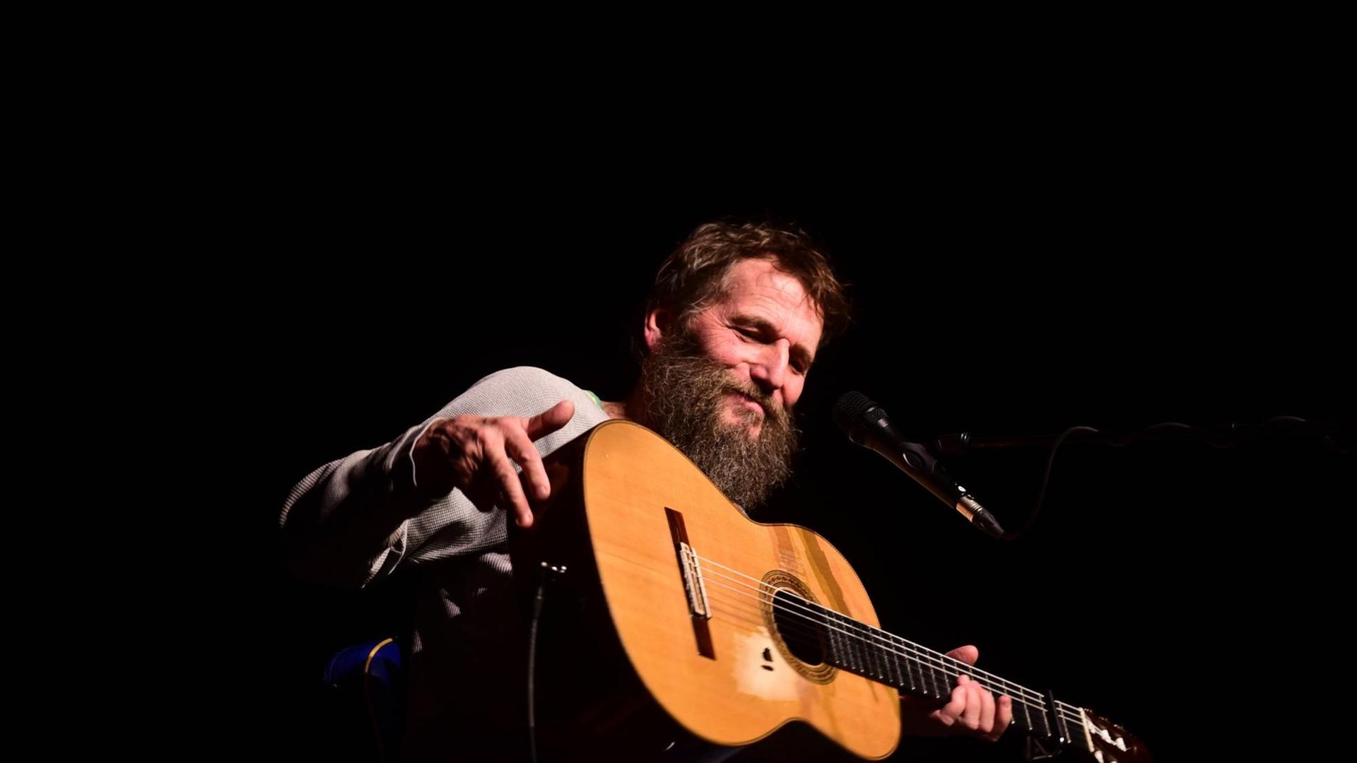 Hans Söllner mit Gitarre auf einer Bühne in Salzburg. Hans Söllner mit Gitarre auf einer Bühne in Salzburg.