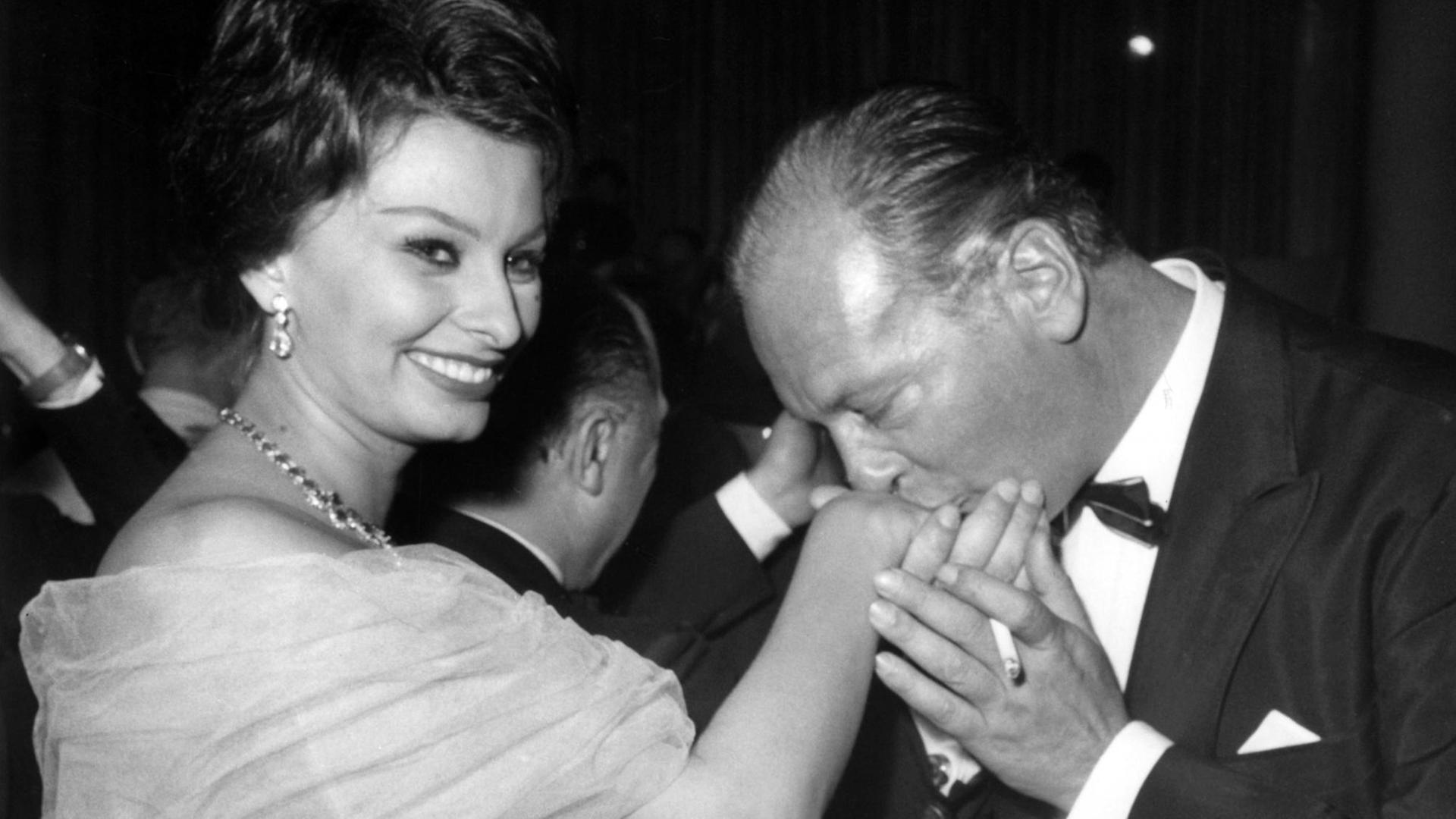 Filmfestspiele Berlin 1959: Der deutsch-österreichische Schauspieler Curd Jürgens küsst die Hand der italienischen Schauspielerin Sophia Loren
