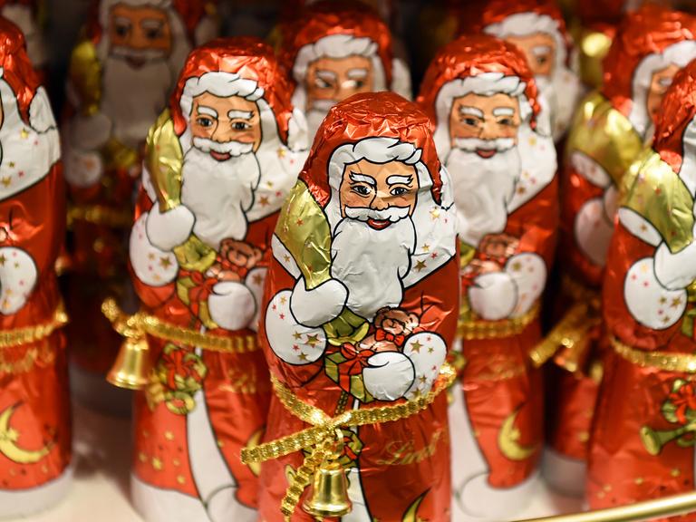 Weihnachtsmänner aus Schokolade stehen in einem Kaufhaus.