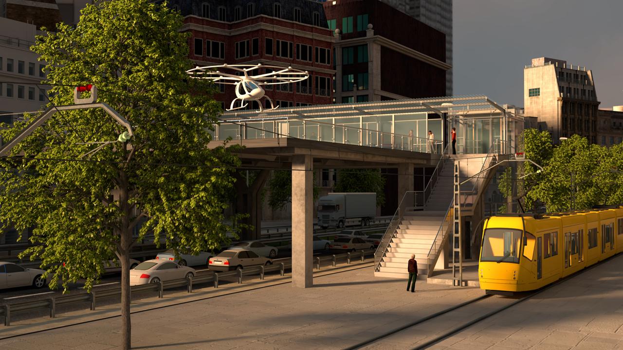 Eine Illustration zeigt wie es funktionieren soll: Ein Volocopter landet auf einem Hub über einer Straße mitten in der Stadt. Eine Illustration zeigt wie es funktionieren soll: Ein Volocopter landet auf einem Hub über einer Straße mitten in der Stadt.