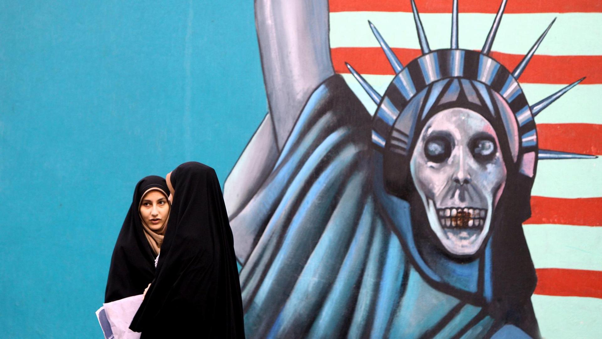 Iranian students walk past a mural outside former US embassy during a demonstration marking the 31th anniversary of US Embassy takeover in Tehran, Iran, 04 November 2010. The rally marks the 31th anniversary of the occupation of the US embassy in Tehran and the 'day of national confrontation against World Imperialism'. Iranian students occupied the embassy on 04 November 1979 after the US granted permission to the late Iranian Shah to be hospitalised in the US. Fifty-three American diplomats and guards were held hostage by students for 444 days. EPA/ABEDIN TAHERKENAREH | Iranian students walk past a mural outside former US embassy during a demonstration marking the 31th anniversary of US Embassy takeover in Tehran, Iran, 04 November 2010. The rally marks the 31th anniversary of the occupation of the US embassy in Tehran and the 'day of national confrontation against World Imperialism'. Iranian students occupied the embassy on 04 November 1979 after the US granted permission to the late Iranian Shah to be hospitalised in the US. Fifty-three American diplomats and guards were held hostage by students for 444 days. EPA/ABEDIN TAHERKENAREH |