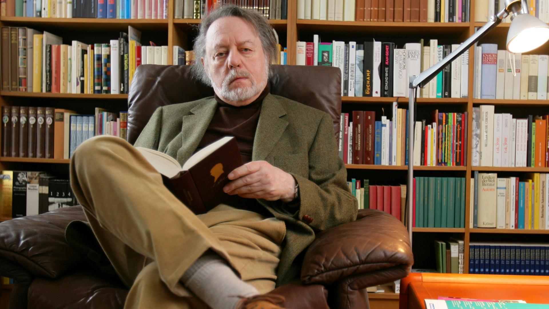 Der Schriftsteller Ror Wolf sitzt am Dienstag (26.02.2008) in seiner Wohnung in Mainz vor einem Bücherregal und blättert in einem Buch. Der Schriftsteller Ror Wolf sitzt am Dienstag (26.02.2008) in seiner Wohnung in Mainz vor einem Bücherregal und blättert in einem Buch.