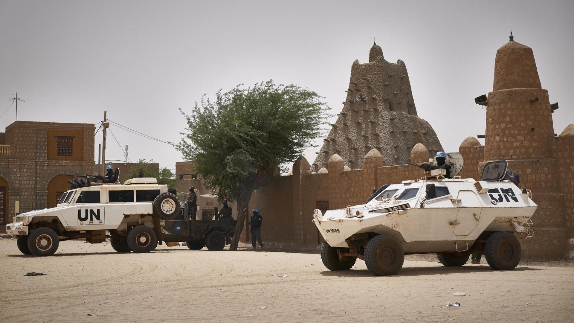 Fahrzeuge von den Vereinten Nationen vor einer Moschee in Timbuktu