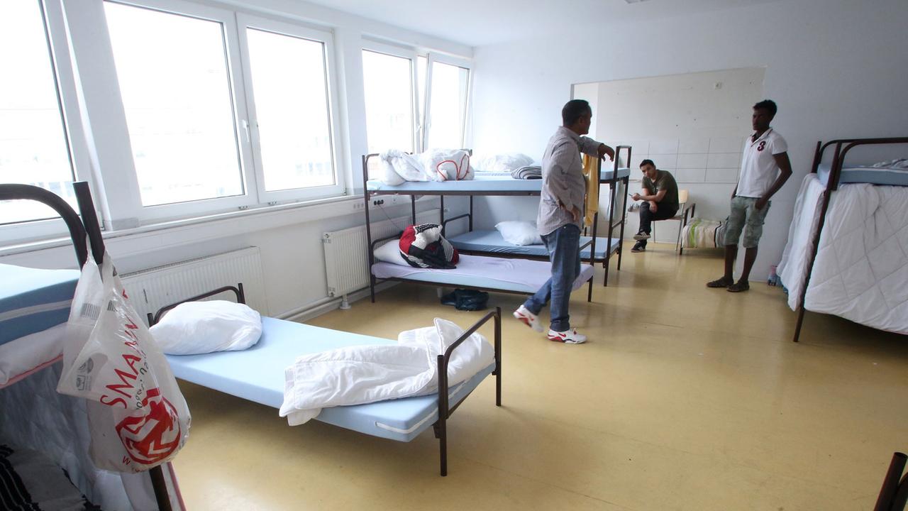 Flüchtlinge halten sich in der Flüchtlingsunterkunft in Essen in ihrem Vielbettzimmer auf. Flüchtlinge halten sich in der Flüchtlingsunterkunft in Essen in ihrem Vielbettzimmer auf.