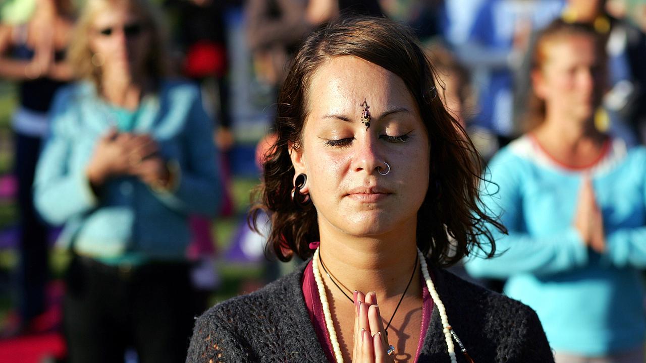 Eine Frau steht in Berlin beim Yogafestival in der Danksagungshaltung "Namaste". Eine Frau steht in Berlin beim Yogafestival in der Danksagungshaltung "Namaste".