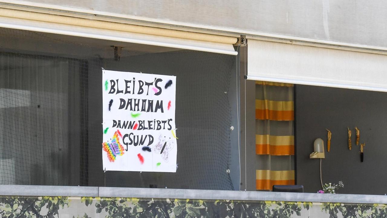 "Bleibt's dahoam, dann bleibt's gsund" - Ein Plakat an einem Balkon in Innsbruck am 23. März 2020. 
