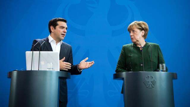 Bundeskanzlerin Angela Merkel (CDU) und der griechische Ministerpräsident Alexis Tsipras sprechen an Redepulten bei einer Pressekonferenz im Bundeskanzleramt