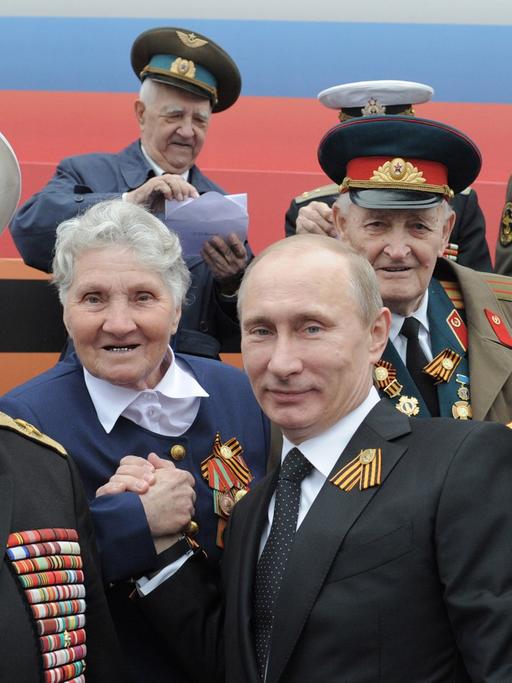 Der russische Präsident Vladimir Putin und Veteranen des Großen Vaterländischen Krieges, am 9. Mai 2012 bei der Siegesparade auf dem Roten Platz in Moskau