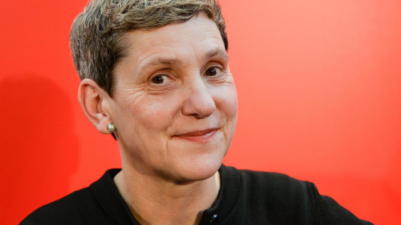 Die Autorin Felicitas Hoppe lächtelt vor einem roten Hintergrund seitlich in die Kamera Die Autorin Felicitas Hoppe lächtelt vor einem roten Hintergrund seitlich in die Kamera