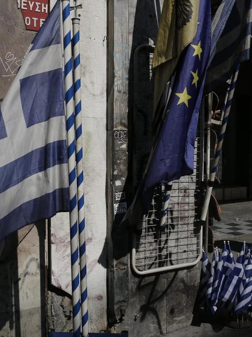 Griechische und europäische Fahnen vor einem Geschäft in Athen