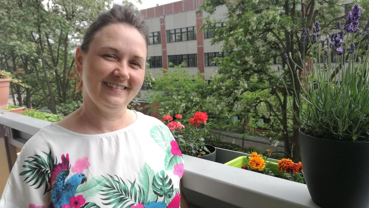 Die alleinerziehende Mutter Adriana Kolliski steht auf einem Balkon und blickt in die Kamera. Die alleinerziehende Mutter Adriana Kolliski steht auf einem Balkon und blickt in die Kamera.