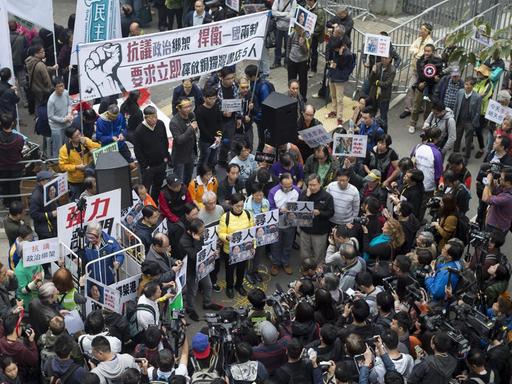 Man sieht eine Menschenmenge in Hongkong, die für Aufklärung über fünf vermisste Buchhändler demonstriert.