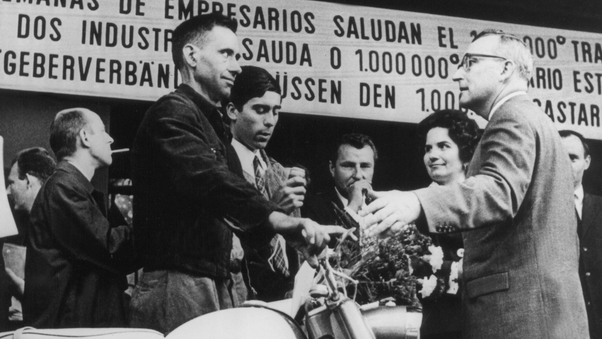Der millionste Gastarbeiter in der Bundesrepublik, Armando Rodrigues de Sa (l.) aus Portugal, steht neben dem Moped, das er bei seiner Ankunft am 10.09.1964 im Köln-Deutzer Bahnhof geschenkt bekam. Der millionste Gastarbeiter in der Bundesrepublik, Armando Rodrigues de Sa (l.) aus Portugal, steht neben dem Moped, das er bei seiner Ankunft am 10.09.1964 im Köln-Deutzer Bahnhof geschenkt bekam.