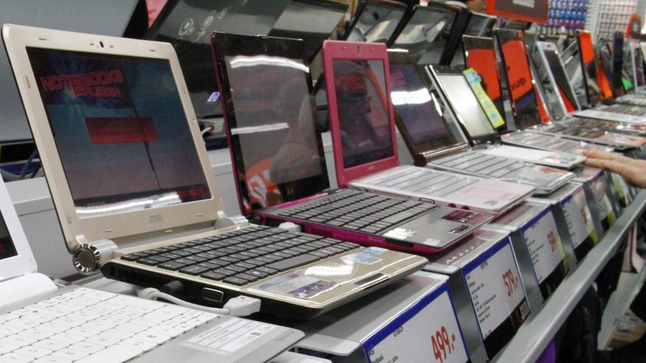 Notebooks und Laptops stehen nebeneinander aufgereiht auf einem Tisch in einem großen Elektonikmarkt. Notebooks und Laptops stehen nebeneinander aufgereiht auf einem Tisch in einem großen Elektonikmarkt.