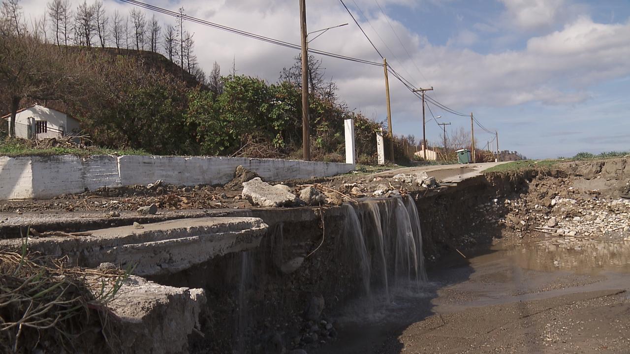 Eine zerstörte Straße auf der Schutt und Geröll liegt und über die sich Wasserströme ergießen. Eine zerstörte Straße auf der Schutt und Geröll liegt und über die sich Wasserströme ergießen.