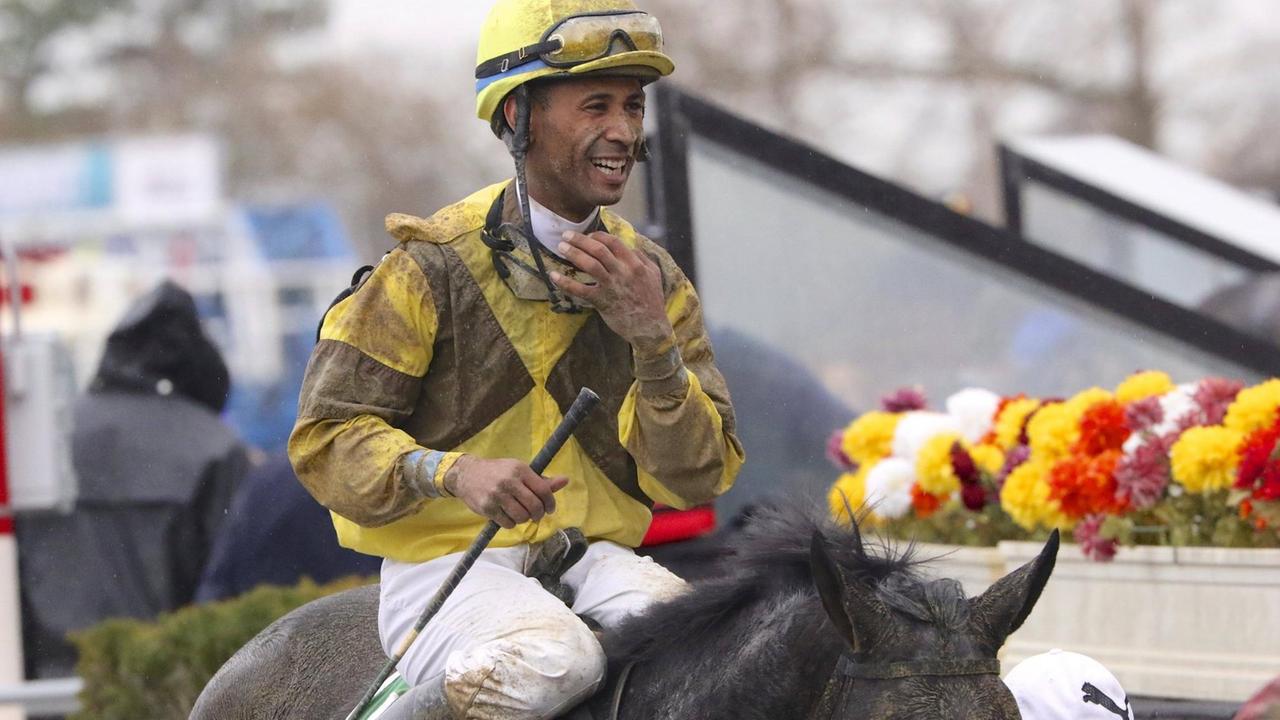 Nov. 28, 2015 - New York, New York, U.S - On a rainy day highlighted by the Cigar Mile Handicap at Aqueduct, jockey KENDRICK CARMOUCHE, seen here heading off the track aboard PANGBURN immediately after the 7th race (the Comely Stakes) earlier that afternoon, smiles despite all the sand and mud residue from their work. Horse Racing 2015 - Cigar Mile Handicap  - ZUMAr112