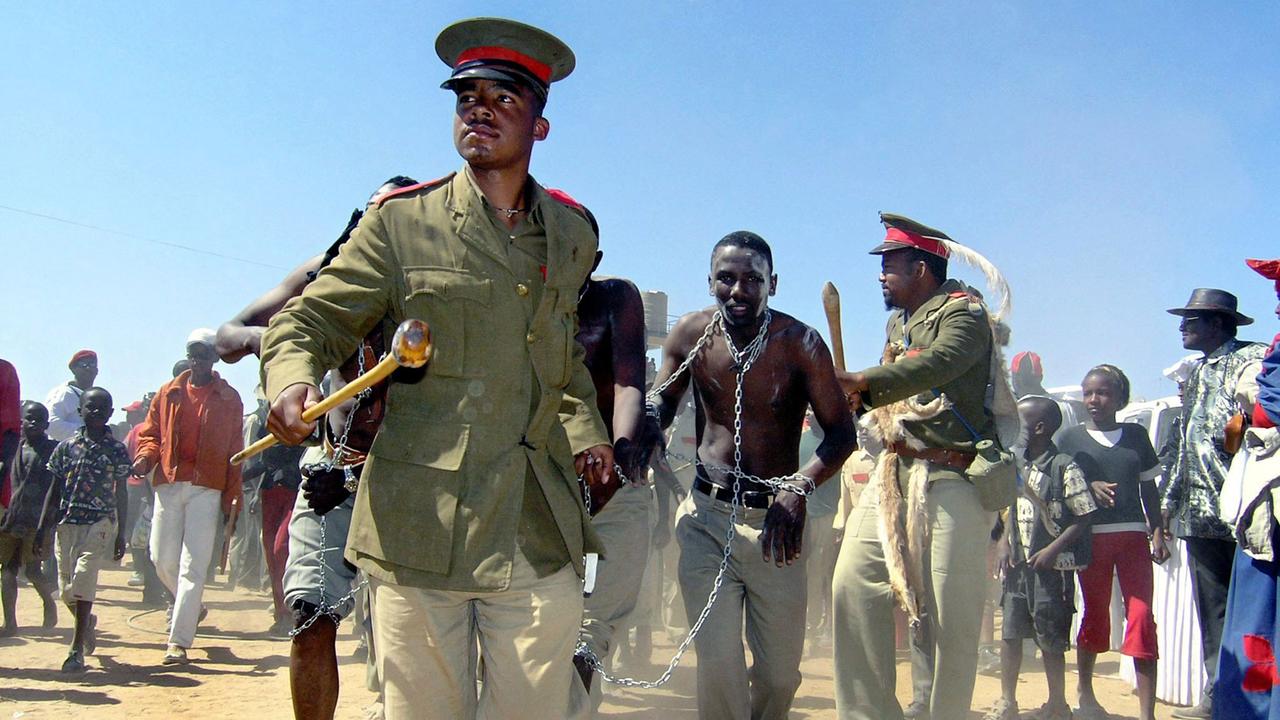 A performance shows the treatment of Hereros in 1904 at a ceremony commemorating the killing of thousands of Hereros by German troops, at Okakarara, 250 km northwest of Windhoek, Namibia, Saturday, 14 August 2004. Germany on Saturday asked the Herero people of Namibia to forgive it for the massacres committed by its troops during a three year uprising 100 years ago. A performance shows the treatment of Hereros in 1904 at a ceremony commemorating the killing of thousands of Hereros by German troops, at Okakarara, 250 km northwest of Windhoek, Namibia, Saturday, 14 August 2004. Germany on Saturday asked the Herero people of Namibia to forgive it for the massacres committed by its troops during a three year uprising 100 years ago.