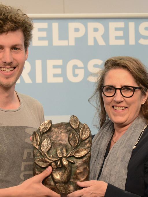 Lucas Derycke und Petra Müller (Geschäftsführerin der Film und Medienstiftung NRW) mit dem Hörspielpreis der Kriegsblinden 2017