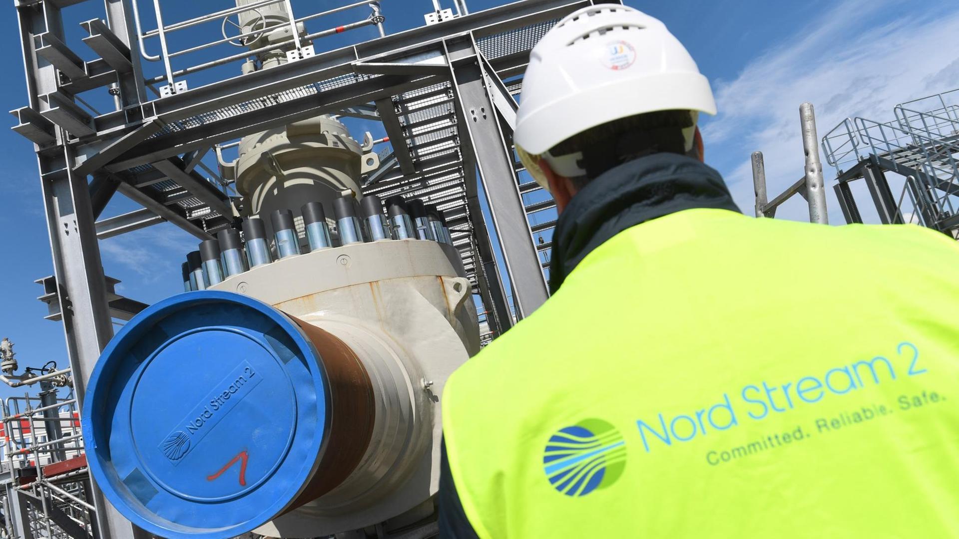 10.07.2019, Mecklenburg-Vorpommern, Lubmin: Ein Arbeiter steht auf der Baustelle der Ostseepipeline Nord Stream 2 an der Molchempfangsstation. Durch die Pipeline soll zum Jahresende das erste russische Erdgas strömen. Die 1.200 Kilometer langen Gaspipeline soll jährlich rund 55 Milliarden Kubikmeter russisches Erdgas von Russland nach Deutschland transportieren. Foto: Stefan Sauer/dpa-Zentralbild/ZB | Verwendung weltweit 10.07.2019, Mecklenburg-Vorpommern, Lubmin: Ein Arbeiter steht auf der Baustelle der Ostseepipeline Nord Stream 2 an der Molchempfangsstation. Durch die Pipeline soll zum Jahresende das erste russische Erdgas strömen. Die 1.200 Kilometer langen Gaspipeline soll jährlich rund 55 Milliarden Kubikmeter russisches Erdgas von Russland nach Deutschland transportieren. Foto: Stefan Sauer/dpa-Zentralbild/ZB | Verwendung weltweit