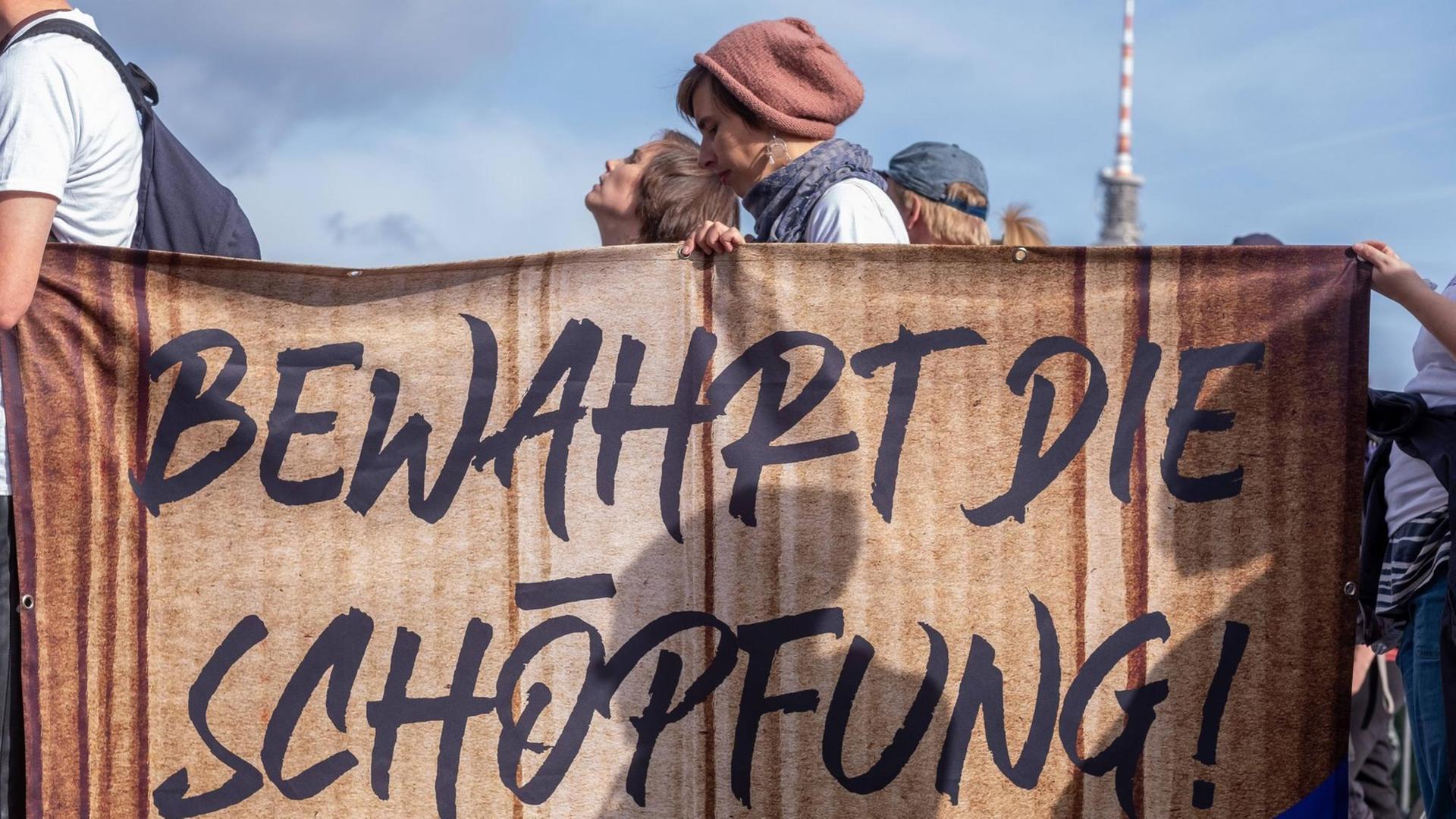Protestierende der Fridays-for-Future-Bewegung halten ein Transparent mit der Aufschrift "Bewahrt die Schöpfung" in die Höhe. Deutschland, Berlin, 20.09.2019 Protestierende der Fridays-for-Future-Bewegung halten ein Transparent mit der Aufschrift "Bewahrt die Schöpfung" in die Höhe. Deutschland, Berlin, 20.09.2019