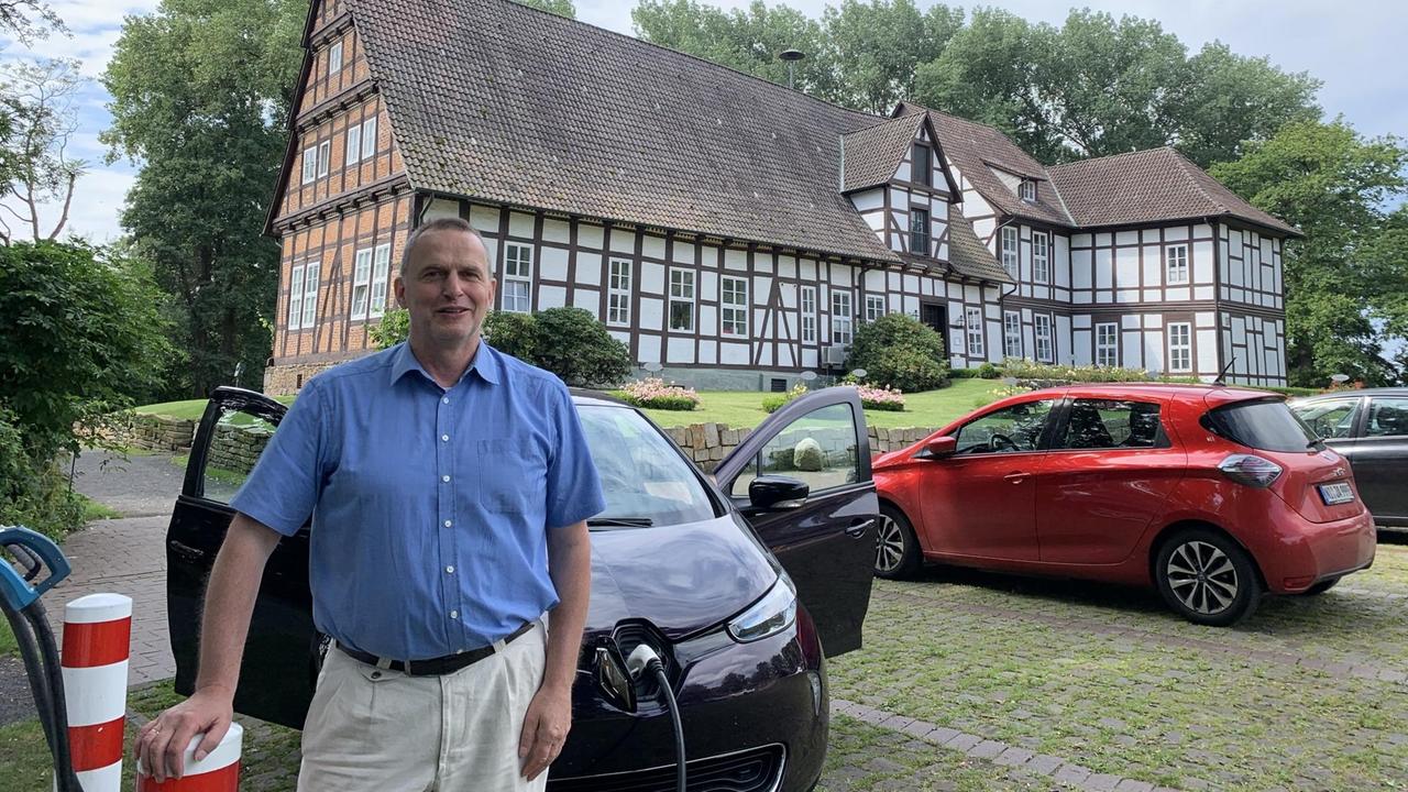 Bürgermeister Heinz-Jürgen Weber CDU steht an der Ladesäule vor dem Amtshaus des Fleckens Steyerberg