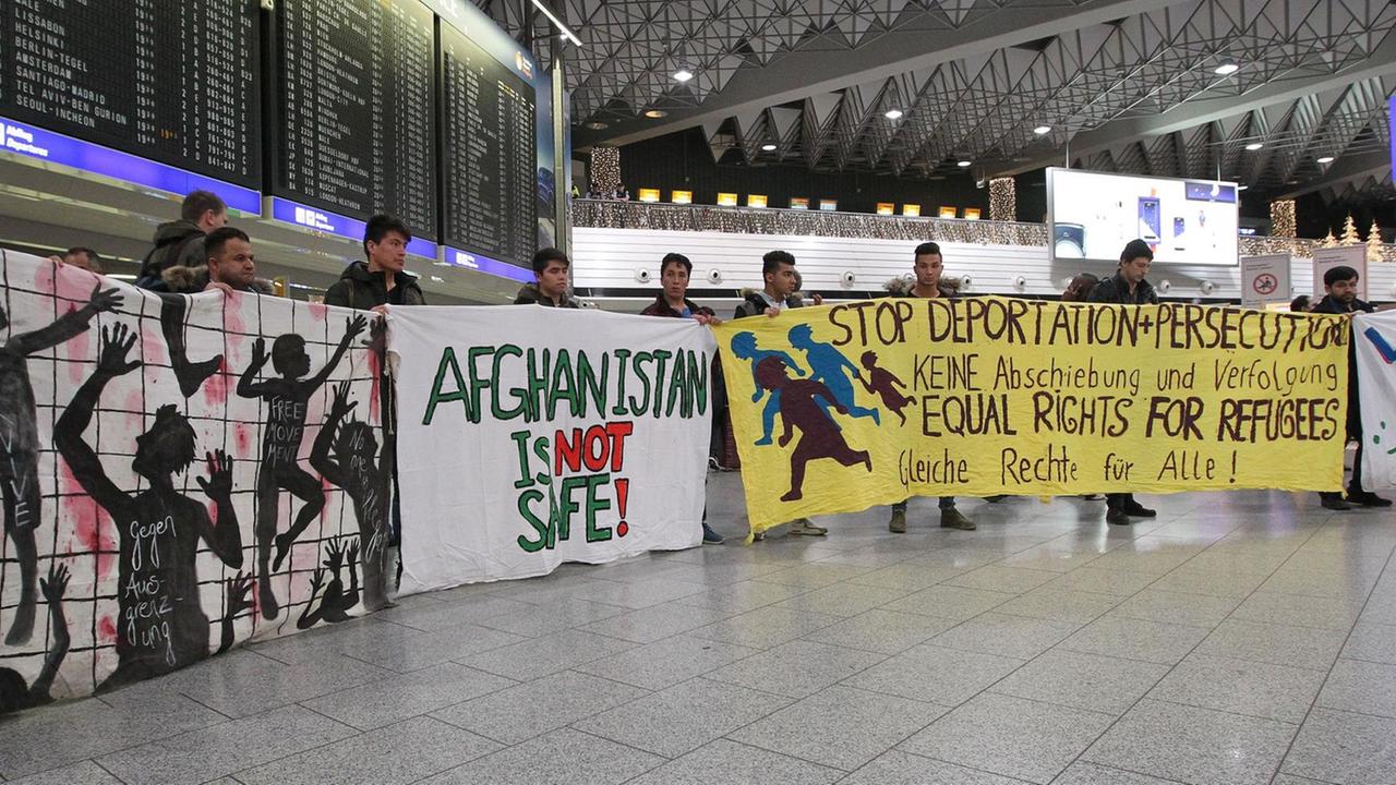 Sie sehen Demonstranten, die in Frankfurt am Main gegen die Abschiebung von Afghanen protestieren. Auf einem der Transparente steht "Afghanistan is not safe". Sie sehen Demonstranten, die in Frankfurt am Main gegen die Abschiebung von Afghanen protestieren. Auf einem der Transparente steht "Afghanistan is not safe".