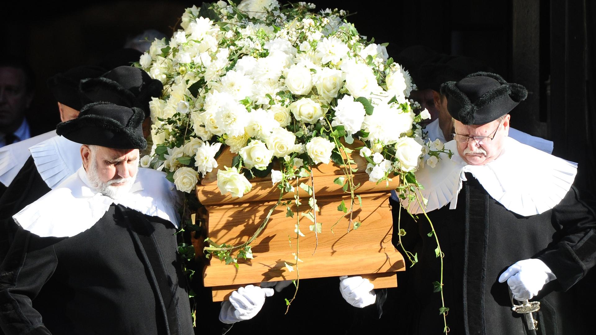 Nach der Trauerfeier für den verstorbenen Schriftsteller Siegfried Lenz in der Hauptkirche St. Michaelis in Hamburg wird am 28.10.2014 der mit weißen Blumen geschmückte Sarg aus der Kirche getragen