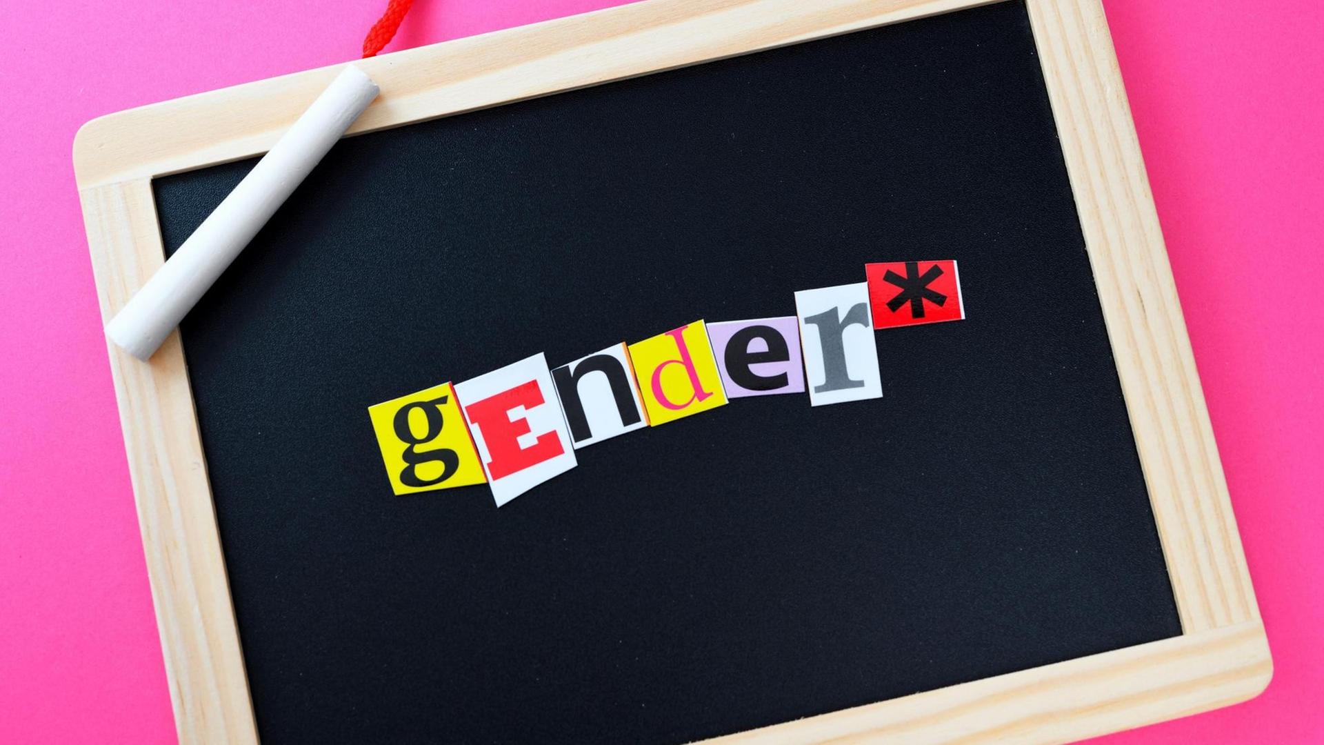 Schultafel mit der Aufschrift Genderstern. Schultafel mit der Aufschrift Genderstern.