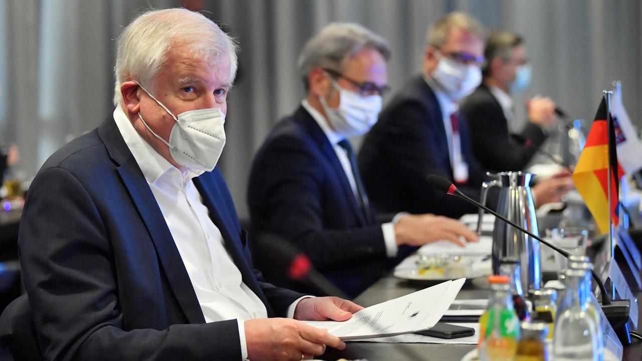 Bundesinnenminister Horst Seehofer (CSU), sitzt mit Mundschutz am Tische  in der Plenarsitzung.