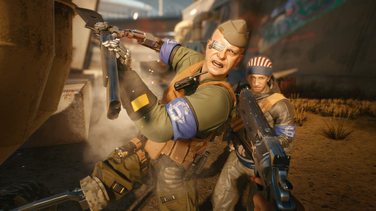 Screenshot aus dem Spiel "Cyberpunk 2077": zwei bis an die Zähne bewaffnete, uniformierte Kämpfer Screenshot aus dem Spiel "Cyberpunk 2077": zwei bis an die Zähne bewaffnete, uniformierte Kämpfer