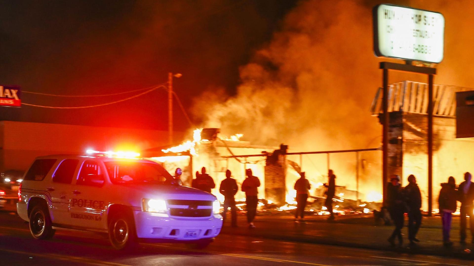 Polizeiauto vor einem brennenden Geschäftshaus in Ferguson (US-Bundesstaat Missouri) in der Nacht zum 25. November Polizeiauto vor einem brennenden Geschäftshaus in Ferguson (US-Bundesstaat Missouri) in der Nacht zum 25. November