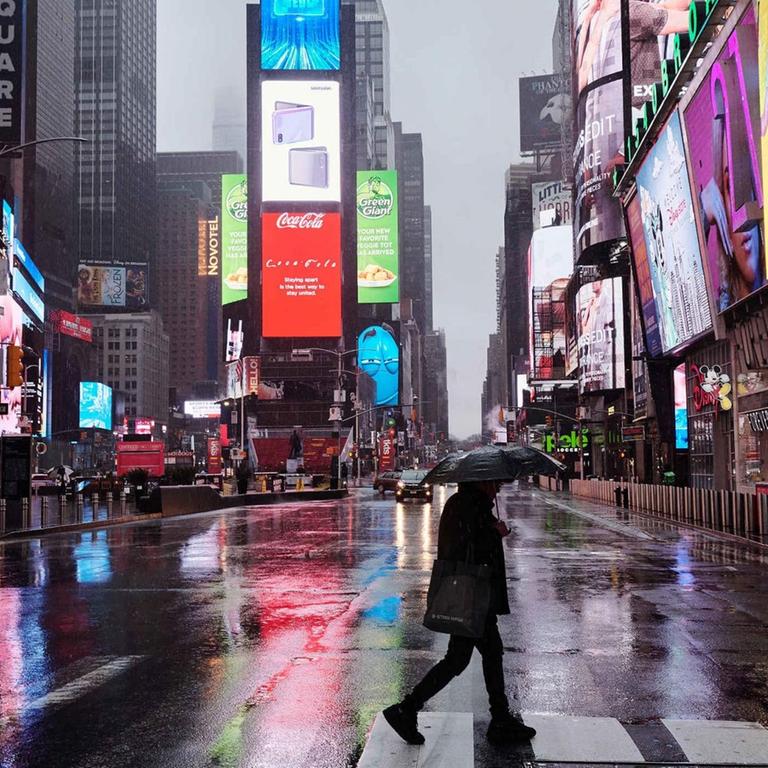 One person crossing street at empty Times Square during the outbreak of coronavirus disease (COVID-19), in New York, United States. New York City after the authorities put the NY state on pause, requiring all non-essential businesses to be closed.