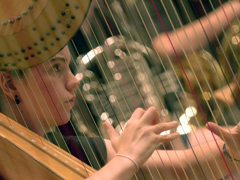 Eine Musikerin des Bundesjugendorchester probt im Konzerthaus in Berlin auf ihrer Harfe.