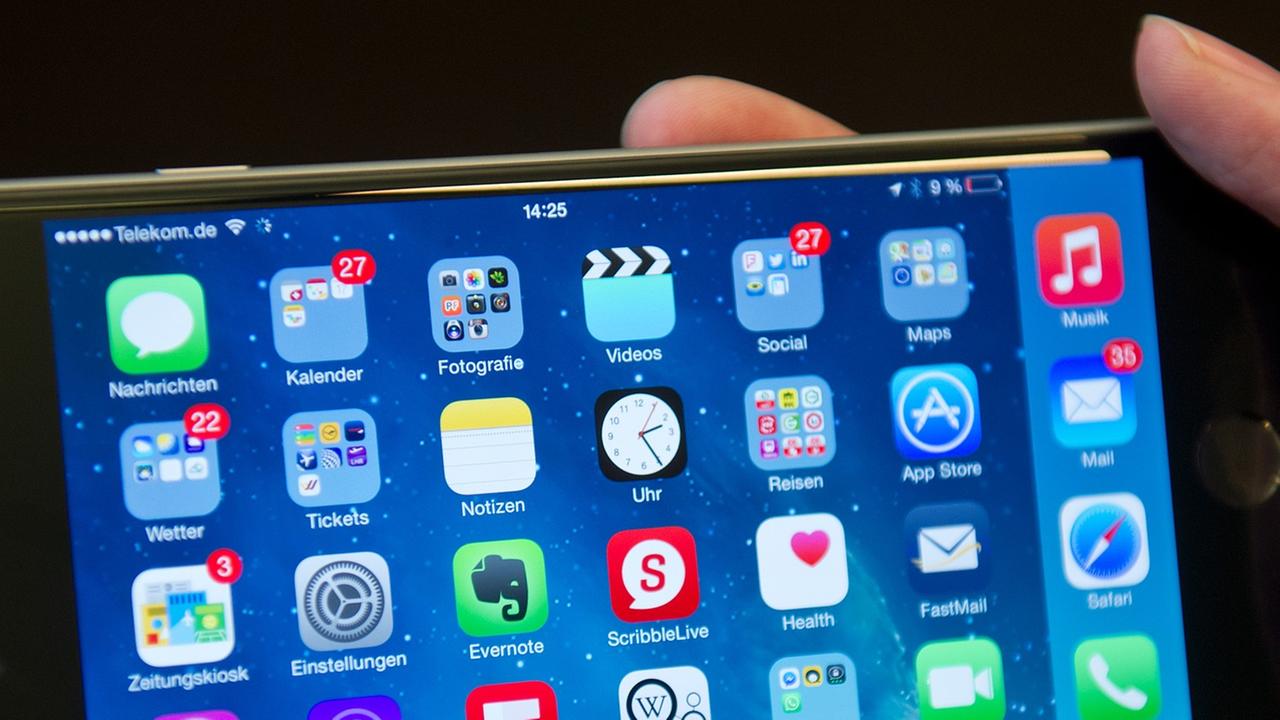 Eine Frau hält in Berlin ein iPhone 6 Plus mit verschiedenen Apps in ihrer Hand. Eine Frau hält in Berlin ein iPhone 6 Plus mit verschiedenen Apps in ihrer Hand.