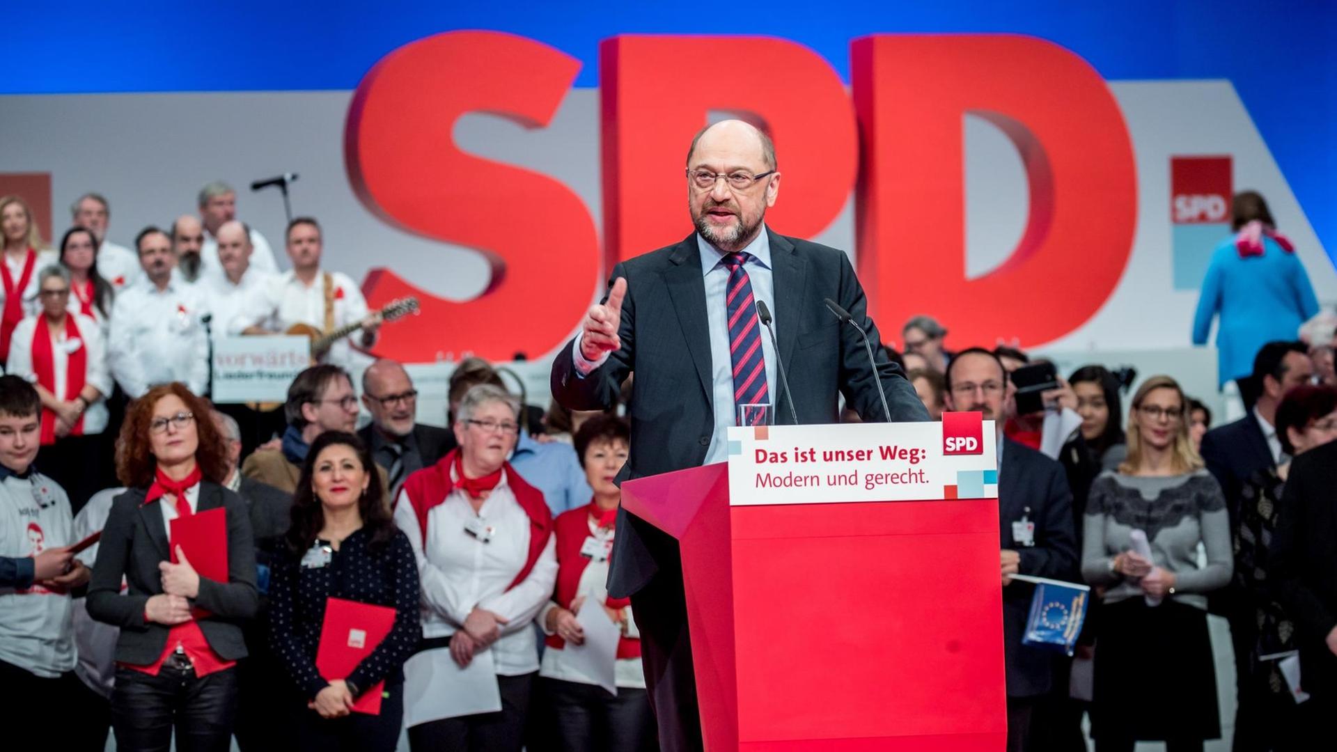 Schulz spricht und gestikuliert an einem Podest mit der Aufschrift "Das ist unser Weg: Modern und gerecht." Dahinter ein übergroßer SPD-Schriftzug und Parteitagsteilnehmer.