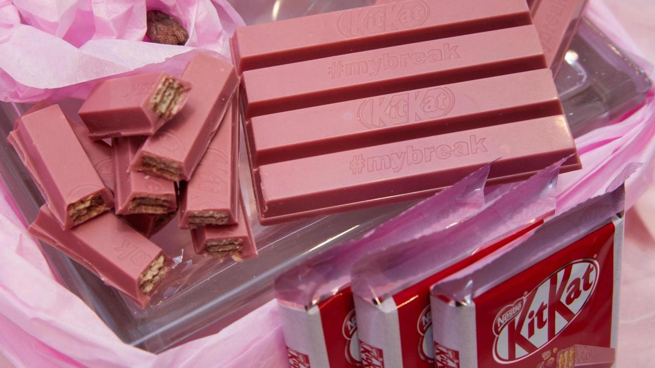 Das Foto zeigt verpackte und unverpackte Tafeln der KitKat Ruby Schokolade von Nestlé.